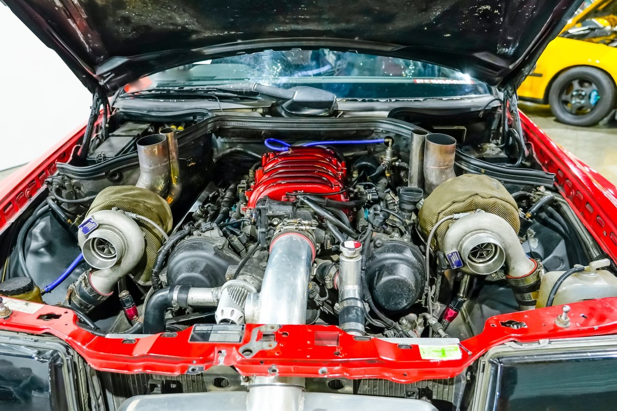 Mechanic working under an open hood